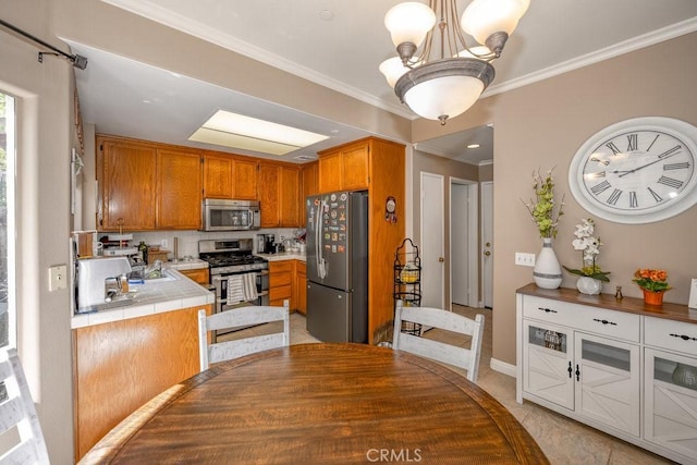 13421 Hubbard St Unit 119, Sylmar, CA 91342 - kitchen with appliances with stainless steel finishes, tile countertops, brown cabinets, ornamental molding, and a chandelier