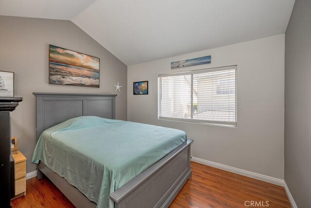 13421 Hubbard St Unit 119, Sylmar, CA 91342 - bedroom featuring vaulted ceiling and wood finished floors