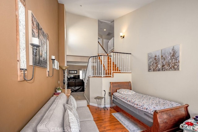 13421 Hubbard St Unit 119, Sylmar, CA 91342 - bedroom with wood finished floors, multiple windows, and a high ceiling