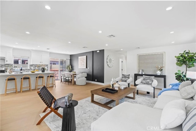 20832 Halldale Ave, Torrance, CA 90501 - living room with recessed lighting and light wood-style flooring