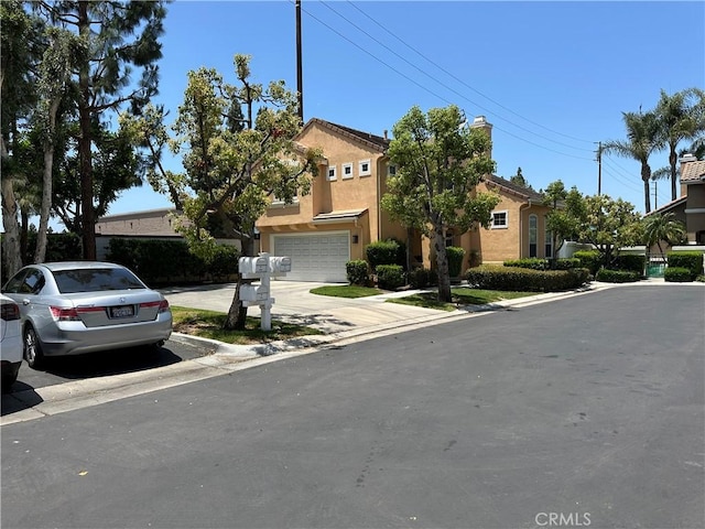 2690 Peralta Ct, Tustin, CA 92782 - view of front of home featuring concrete driveway, an attached garage, and stucco siding