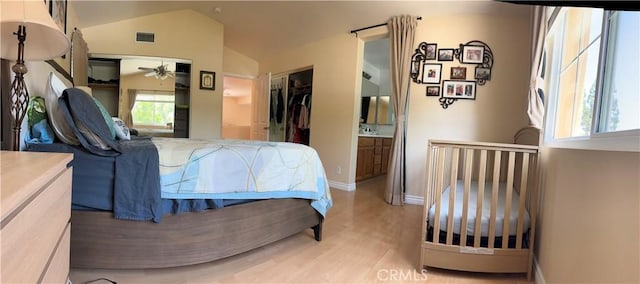 2690 Peralta Ct, Tustin, CA 92782 - bedroom with light wood-style floors, vaulted ceiling, and ensuite bathroom