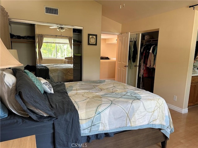 2690 Peralta Ct, Tustin, CA 92782 - bedroom featuring wood finished floors, lofted ceiling, and two closets