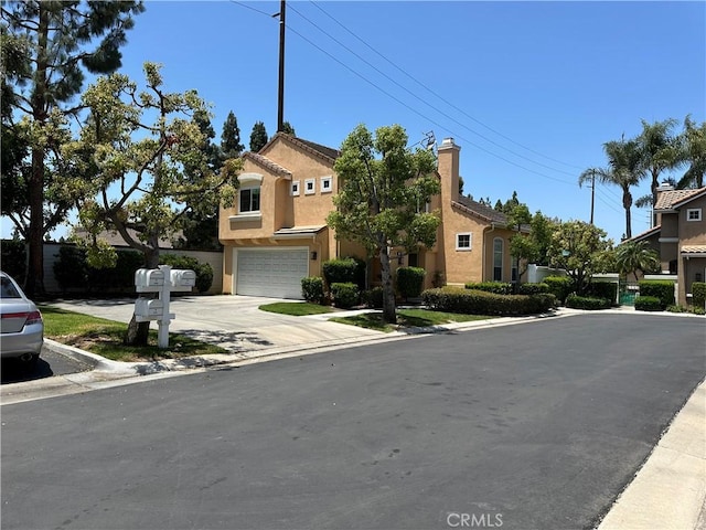 2690 Peralta Ct, Tustin, CA 92782 - view of front of house featuring a garage, stucco siding, and concrete driveway