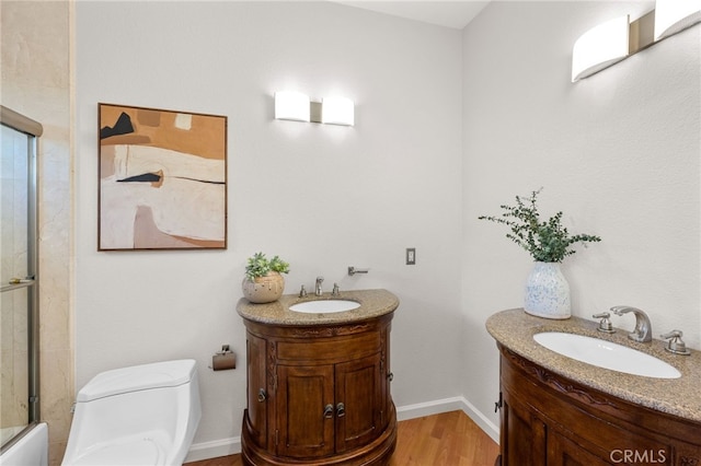 210 N Stage Coach Ln, Fallbrook, CA 92028 - bathroom featuring vanity, wood finished floors, and enclosed tub / shower combo