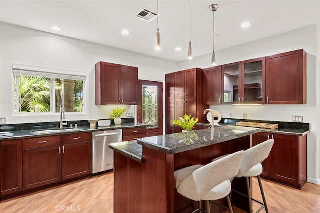 210 N Stage Coach Ln, Fallbrook, CA 92028 - kitchen with dishwasher, dark brown cabinets, a center island, light wood-style flooring, and hanging light fixtures