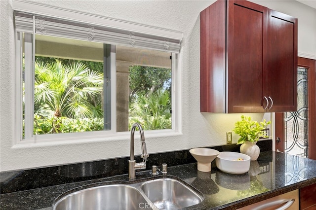 210 N Stage Coach Ln, Fallbrook, CA 92028 - kitchen with dark brown cabinets, dark stone countertops, and a textured wall