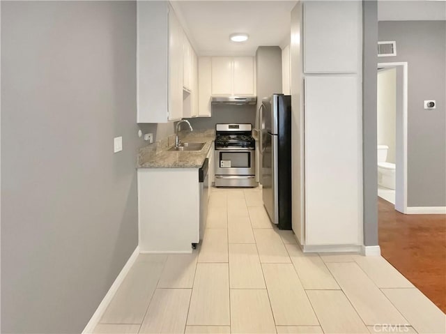 14560 Clark St Unit 202, Sherman Oaks, CA 91411 - kitchen featuring stainless steel appliances, under cabinet range hood, white cabinets, light stone counters, and light tile patterned floors