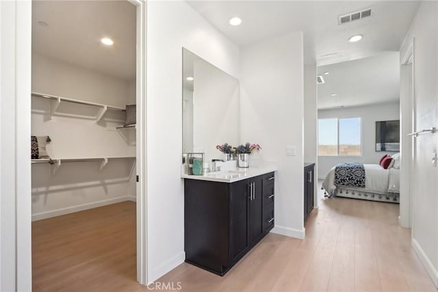 38840 Malva Rosa Dr, Palmdale, CA 93551 - ensuite bathroom featuring vanity, wood finished floors, recessed lighting, and a spacious closet