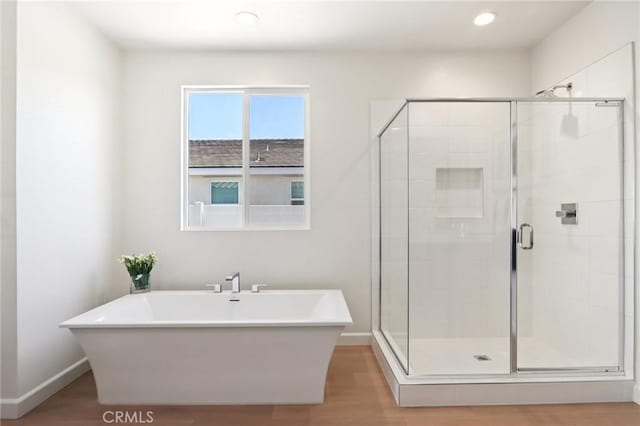 38840 Malva Rosa Dr, Palmdale, CA 93551 - full bath with a freestanding tub, a shower stall, wood finished floors, and recessed lighting
