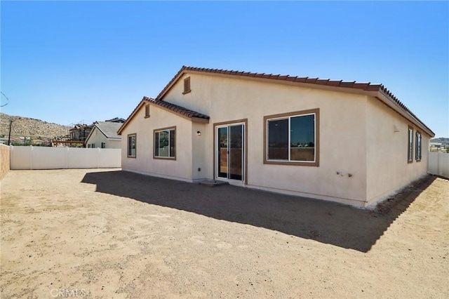 38840 Malva Rosa Dr, Palmdale, CA 93551 - rear view of property featuring a fenced backyard, stucco siding, and a tiled roof