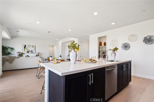 38840 Malva Rosa Dr, Palmdale, CA 93551 - kitchen with stainless steel dishwasher, light wood-type flooring, an island with sink, light countertops, and recessed lighting
