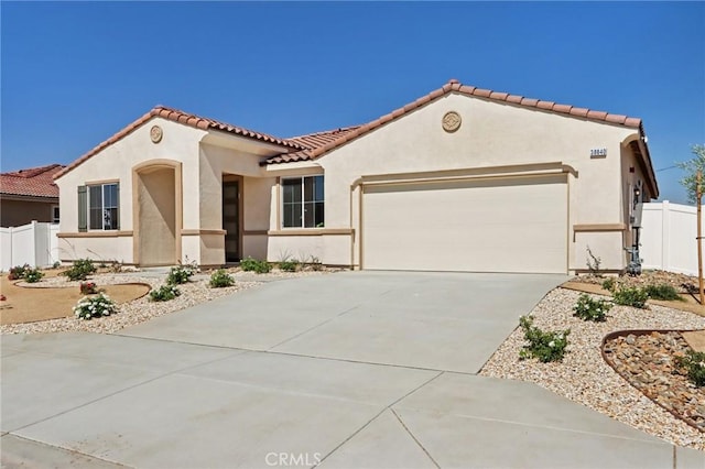 38840 Malva Rosa Dr, Palmdale, CA 93551 - mediterranean / spanish-style home featuring a tile roof, a garage, stucco siding, and concrete driveway
