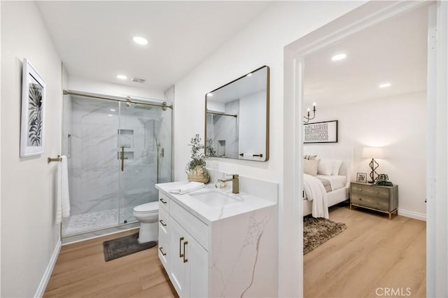 26592 Tampico Pl, Mission Viejo, CA 92691 - bathroom featuring wood finished floors, vanity, a marble finish shower, and recessed lighting