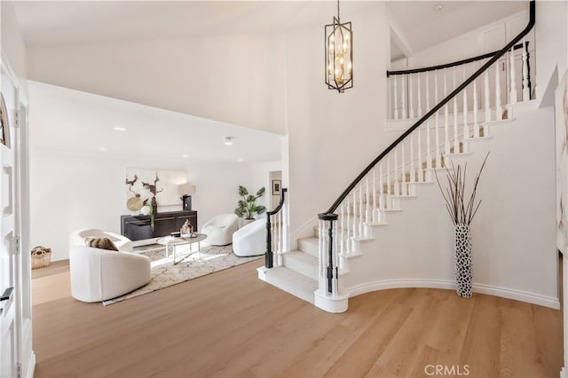 26592 Tampico Pl, Mission Viejo, CA 92691 - foyer entrance featuring high vaulted ceiling, stairs, light wood finished floors, and a chandelier