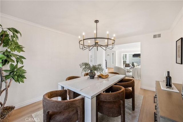26592 Tampico Pl, Mission Viejo, CA 92691 - dining room with a chandelier, light wood-style flooring, and crown molding