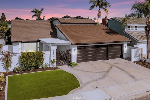 26592 Tampico Pl, Mission Viejo, CA 92691 - view of front facade featuring a garage, concrete driveway, a tile roof, stucco siding, and a gate