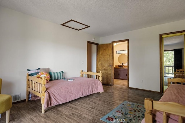 161 Pine Ridge Rd, Crestline, CA 92325 - bedroom featuring attic access, wood finished floors, a textured ceiling, and ensuite bathroom