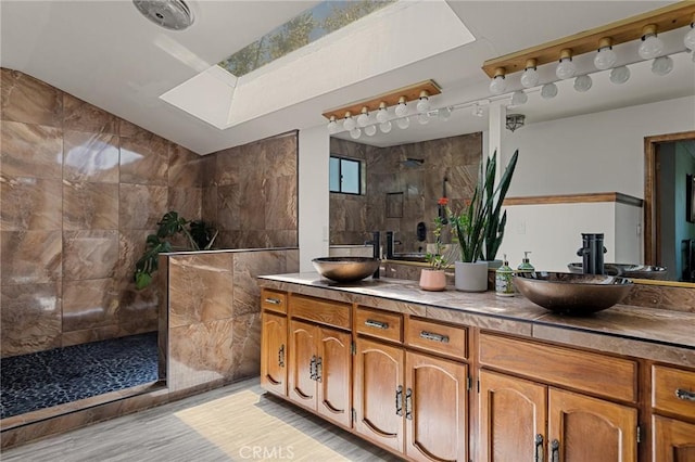 161 Pine Ridge Rd, Crestline, CA 92325 - bathroom featuring double vanity, walk in shower, vaulted ceiling, and wood finished floors