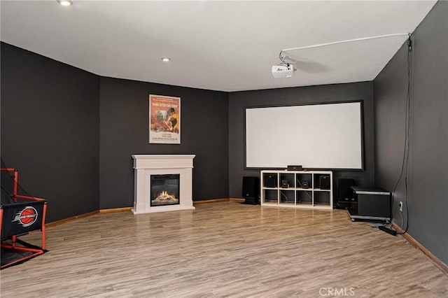 161 Pine Ridge Rd, Crestline, CA 92325 - cinema room with wood finished floors, a glass covered fireplace, and recessed lighting