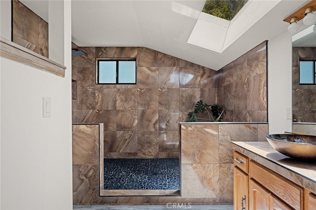 161 Pine Ridge Rd, Crestline, CA 92325 - bathroom featuring vanity, walk in shower, vaulted ceiling, and a skylight