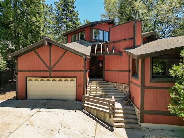 161 Pine Ridge Rd, Crestline, CA 92325 - view of front of home with concrete driveway, roof with shingles, and stairs