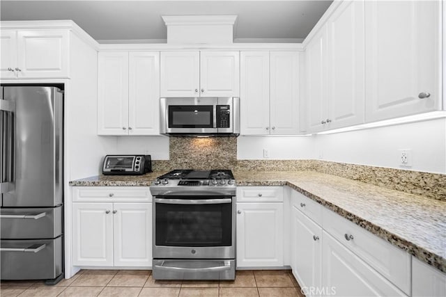 20916 Jade Dr, Walnut, CA 91789 - kitchen with stainless steel appliances, white cabinets, light tile patterned floors, light stone counters, and decorative backsplash