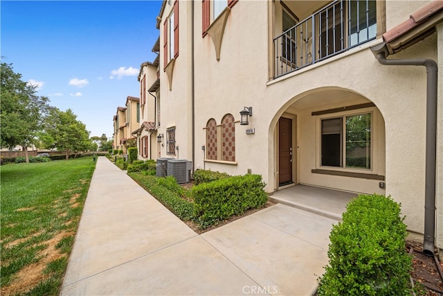 20916 Jade Dr, Walnut, CA 91789 - view of exterior entry featuring stucco siding, a balcony, and a yard