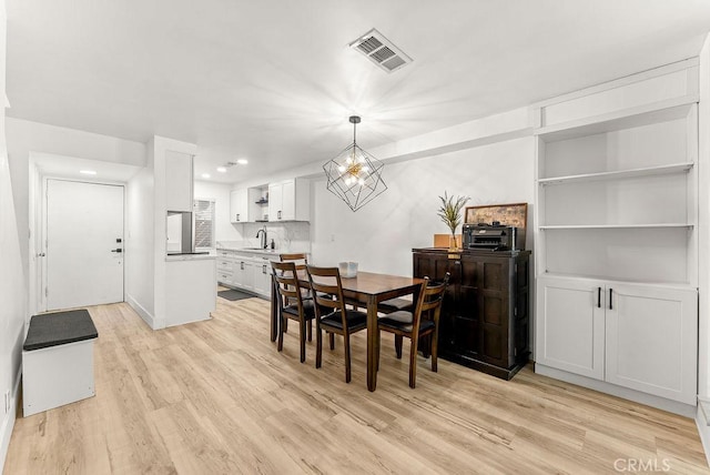 1745 Neil Armstrong Ave Unit 104, Montebello, CA 90640 - dining area with light wood-style flooring, recessed lighting, and a chandelier
