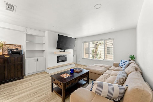 1745 Neil Armstrong Ave Unit 104, Montebello, CA 90640 - living room with light wood-style flooring and a glass covered fireplace