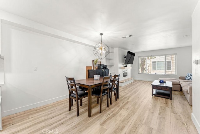 1745 Neil Armstrong Ave Unit 104, Montebello, CA 90640 - dining room with wood finished floors and a glass covered fireplace