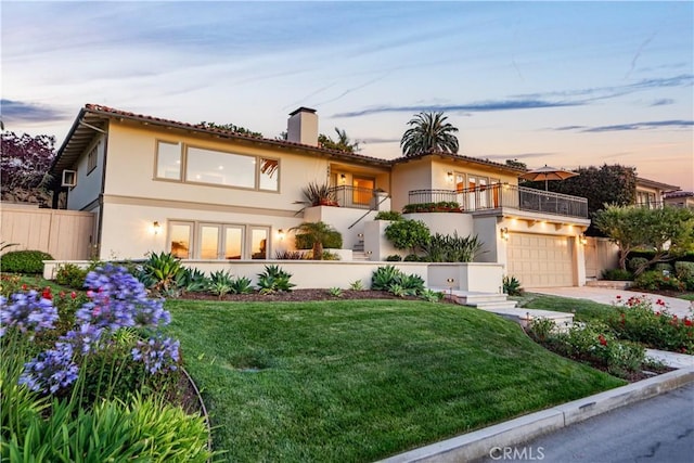 869 Rincon Ln, Palos Verdes Estates, CA 90274 - mediterranean / spanish-style house with a balcony, stucco siding, concrete driveway, a chimney, and a garage