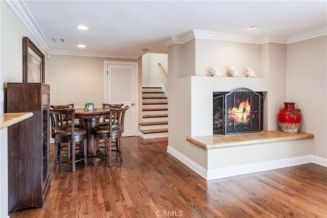 869 Rincon Ln, Palos Verdes Estates, CA 90274 - dining space with stairs, dark wood-style flooring, a lit fireplace, recessed lighting, and crown molding