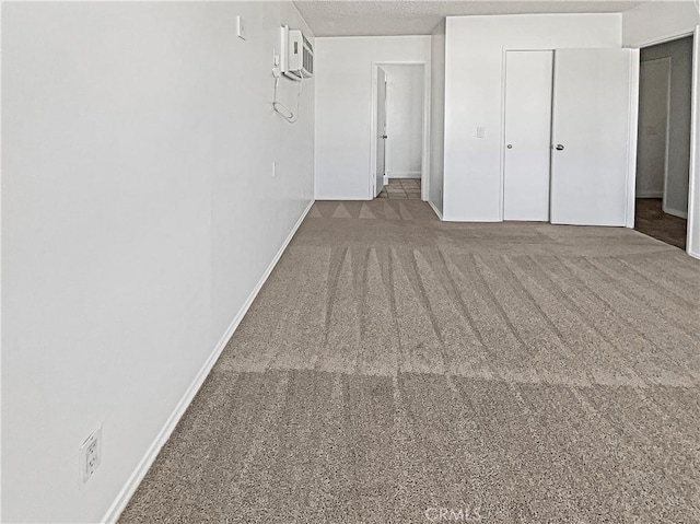 8800 Cedros Ave Unit 209, Panorama City, CA 91402 - unfurnished bedroom with carpet flooring, a closet, a textured ceiling, and a wall unit AC