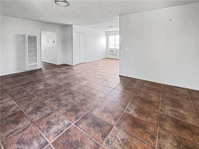 8800 Cedros Ave Unit 209, Panorama City, CA 91402 - unfurnished room with a heating unit, a textured ceiling, and dark tile patterned flooring