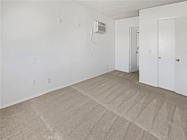 8800 Cedros Ave Unit 209, Panorama City, CA 91402 - empty room featuring an AC wall unit, a textured ceiling, and carpet