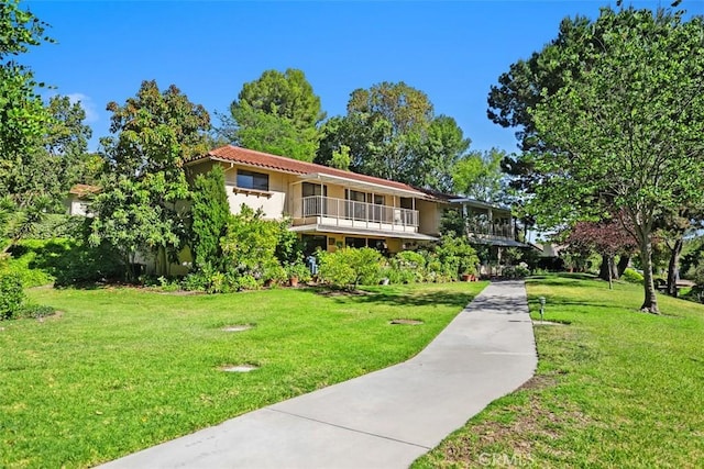 905 Ronda Sevilla Unit 0, Laguna Woods, CA 92637 - view of front of home with a front yard, a tiled roof, and a balcony