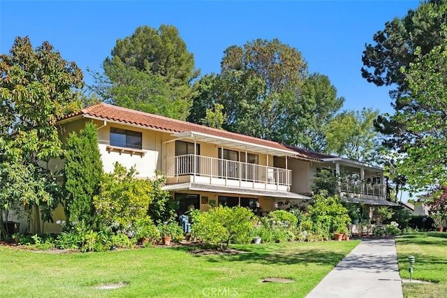 905 Ronda Sevilla Unit 0, Laguna Woods, CA 92637 - view of front facade with a balcony, a front yard, and stucco siding