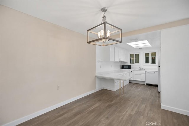 905 Ronda Sevilla Unit 0, Laguna Woods, CA 92637 - kitchen featuring white appliances, white cabinetry, a chandelier, a peninsula, and wood finished floors