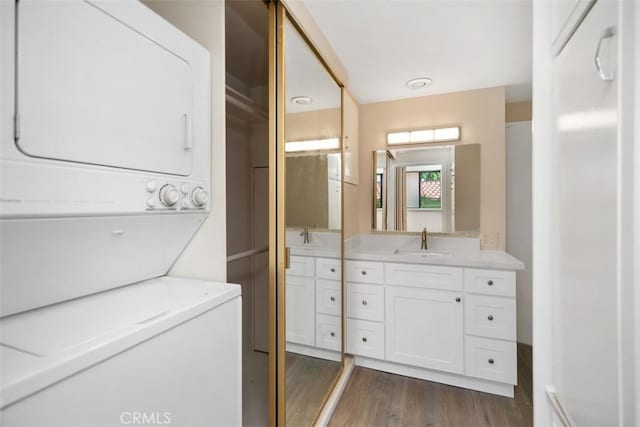 905 Ronda Sevilla Unit 0, Laguna Woods, CA 92637 - full bath with stacked washer / drying machine, vanity, and wood finished floors
