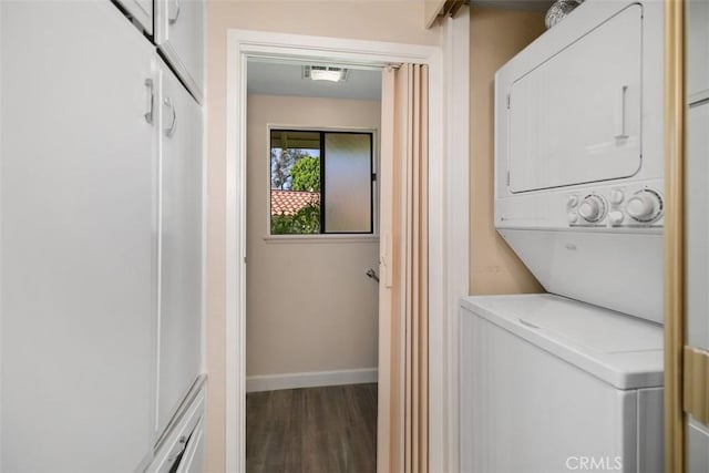 905 Ronda Sevilla Unit 0, Laguna Woods, CA 92637 - laundry area with stacked washer and clothes dryer and wood finished floors