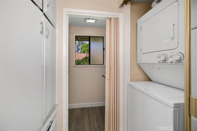 905 Ronda Sevilla Unit O, Laguna Woods, CA 92637 - laundry area with stacked washer and clothes dryer and wood finished floors