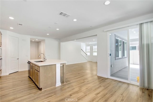 32210 Hillstone St, Temecula, CA 92591 - kitchen featuring open floor plan, an island with sink, light wood-type flooring, recessed lighting, and light countertops
