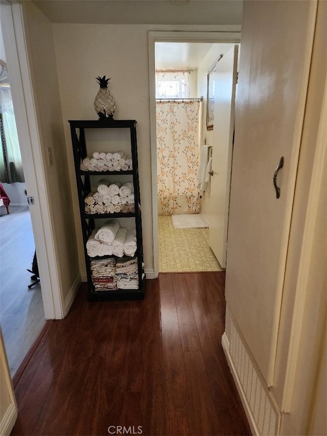 15116 S Raymond Ave Unit 104, Gardena, CA 90247 - hallway featuring dark wood-style flooring and baseboards