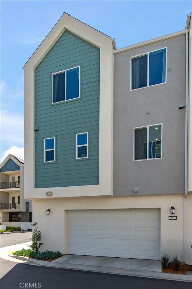 251 Sash, Irvine, CA 92618 - view of front of property featuring stucco siding, an attached garage, and driveway