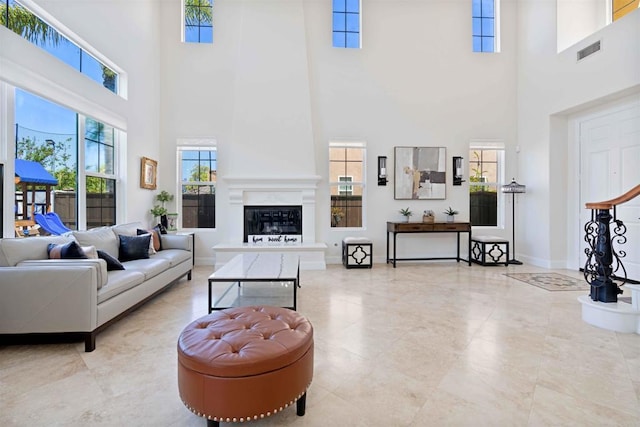 2814 Rambling Vista Rd, Chula Vista, CA 91915 - living room featuring a high ceiling, plenty of natural light, and a glass covered fireplace