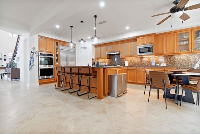 2814 Rambling Vista Rd, Chula Vista, CA 91915 - kitchen with built in appliances, crown molding, under cabinet range hood, decorative backsplash, and a kitchen breakfast bar