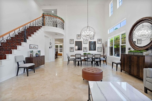 2814 Rambling Vista Rd, Chula Vista, CA 91915 - living area with a chandelier, a towering ceiling, stairway, crown molding, and arched walkways