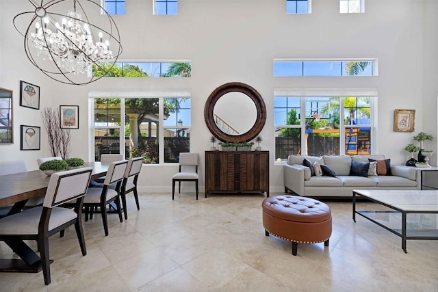 2814 Rambling Vista Rd, Chula Vista, CA 91915 - living room with a high ceiling, a chandelier, healthy amount of natural light, and light tile patterned flooring