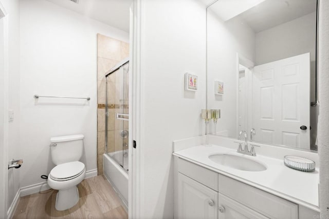 2814 Rambling Vista Rd, Chula Vista, CA 91915 - bathroom featuring vanity, combined bath / shower with glass door, and wood finished floors